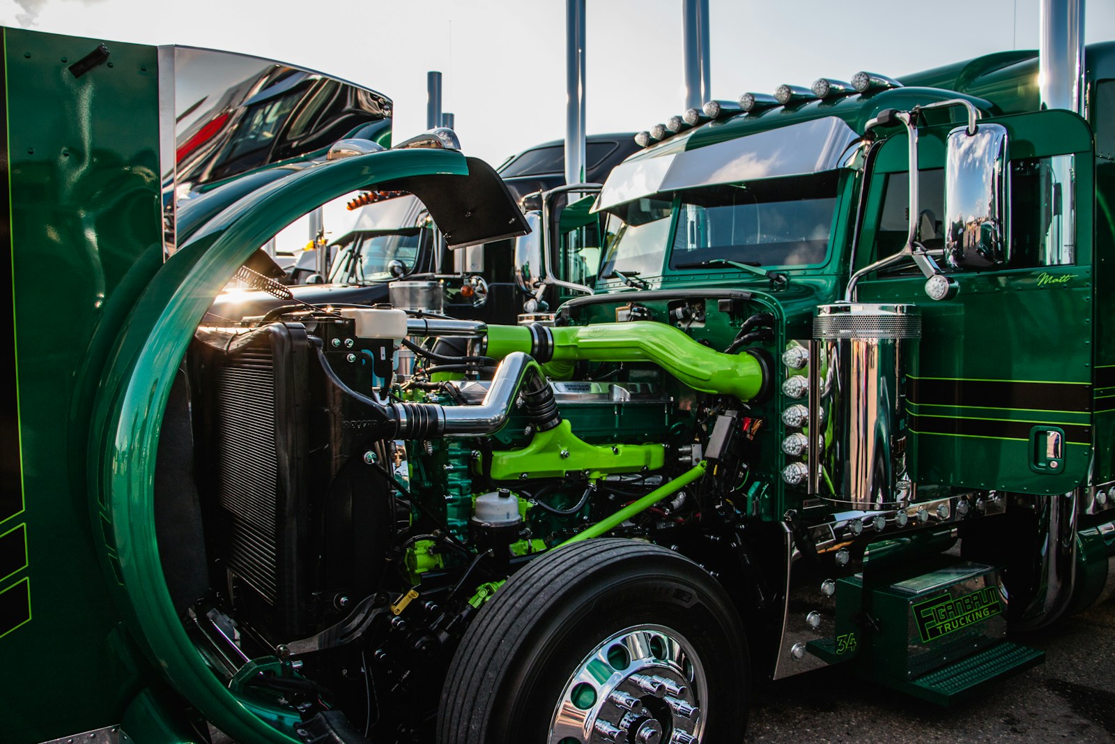 a close up of the front of a green semi truck